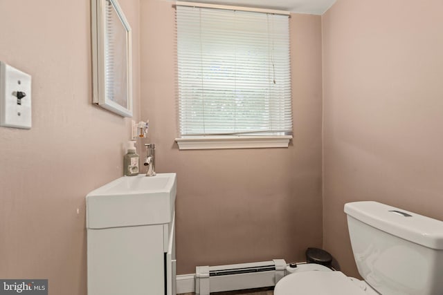 bathroom featuring a baseboard heating unit and toilet