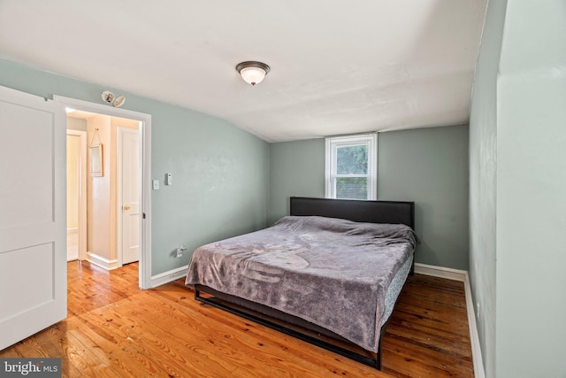 bedroom with light wood-style floors and baseboards