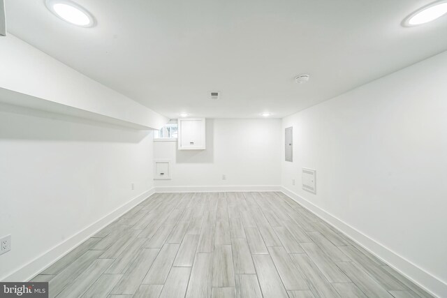 1309 S 32nd St, Philadelphia, PA 19146 - below grade area featuring light wood-style flooring, electric panel, baseboards, and recessed lighting