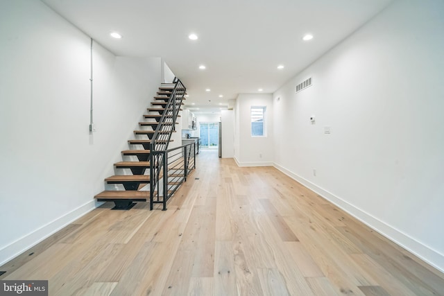 1309 S 32nd St, Philadelphia, PA 19146 - unfurnished living room featuring stairway, baseboards, light wood-style flooring, and recessed lighting