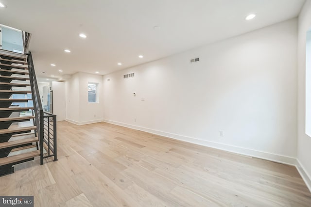 1309 S 32nd St, Philadelphia, PA 19146 - unfurnished living room with light wood-style floors, recessed lighting, baseboards, and stairway