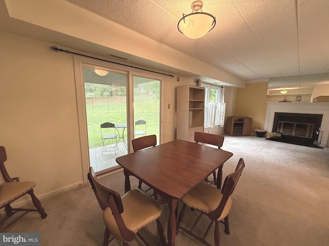 2007 Windfield Ct Unit 2007, Glen Mills, PA 19342 - carpeted dining space featuring a glass covered fireplace, baseboards, and a textured ceiling