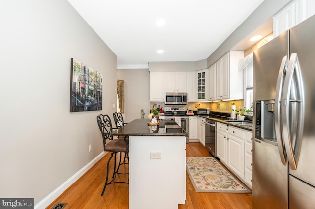 1280 Saint Michaels Rd, Mount Airy, MD 21771 - kitchen featuring stainless steel appliances, a kitchen bar, light wood-type flooring, white cabinetry, and recessed lighting