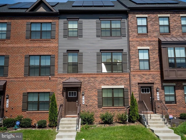 194 Green Poplar Loop, Clarksburg, MD 20871 - townhome / multi-family property with brick siding, solar panels, and entry steps