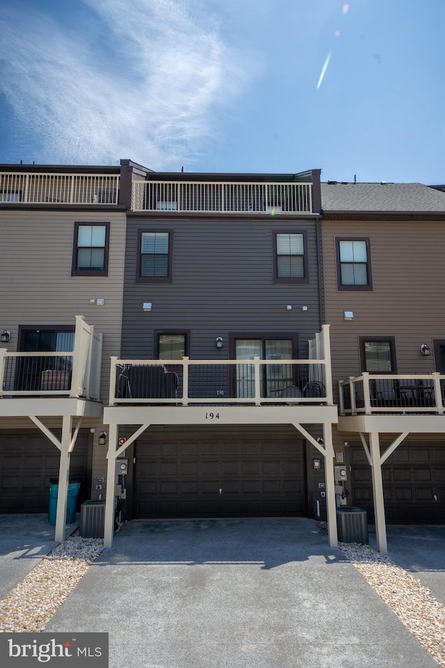 194 Green Poplar Loop, Clarksburg, MD 20871 - rear view of property with asphalt driveway, a garage, and cooling unit