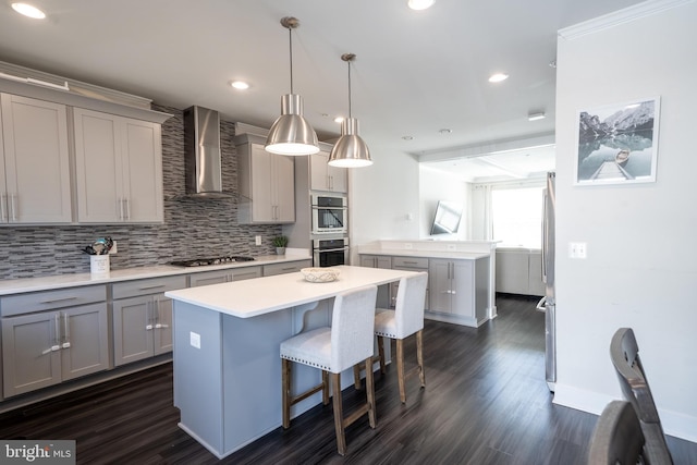 194 Green Poplar Loop, Clarksburg, MD 20871 - kitchen featuring wall chimney exhaust hood, gray cabinets, a kitchen island, stainless steel appliances, and backsplash