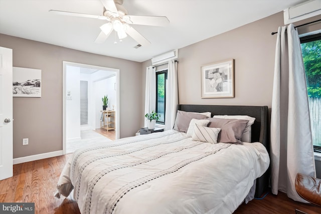 bedroom featuring wood finished floors, baseboards, and ceiling fan