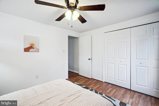 bedroom featuring wood finished floors, a closet, and ceiling fan
