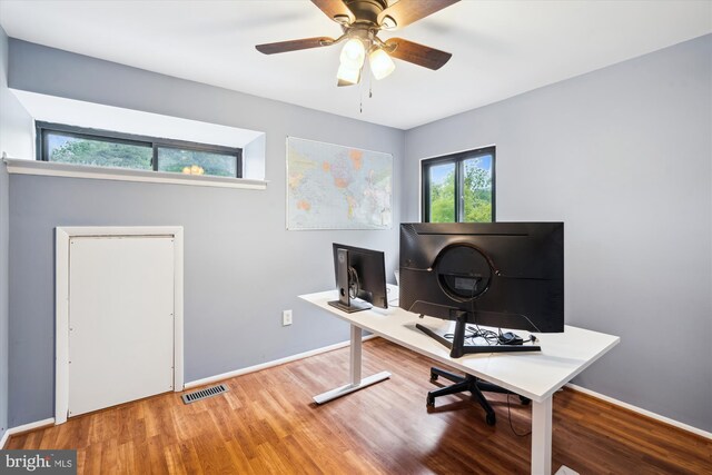 office featuring wood finished floors, baseboards, and a ceiling fan