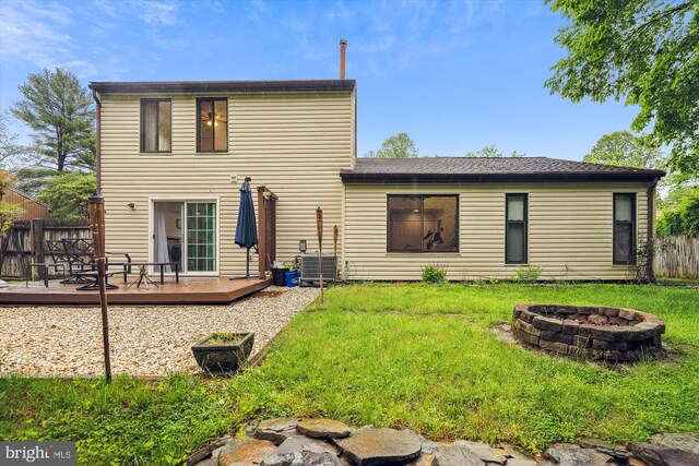 rear view of house featuring an outdoor fire pit, a deck, and central air condition unit