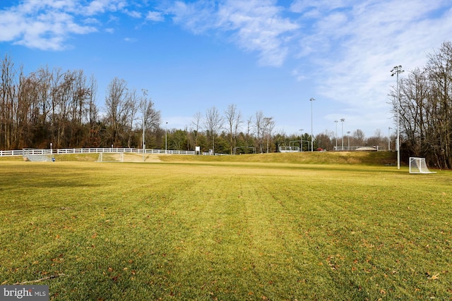 view of home's community with an area for soccer and fence