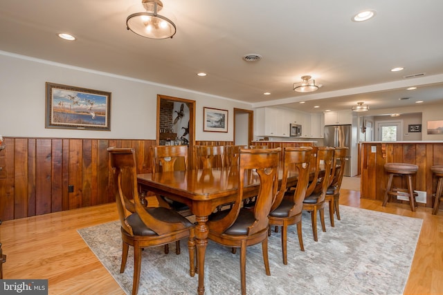 3706 Bestpitch Ferry Rd, Cambridge, MD 21613 - dining area with wainscoting, crown molding, light wood-type flooring, recessed lighting, and wood walls