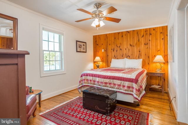 3706 Bestpitch Ferry Rd, Cambridge, MD 21613 - bedroom with crown molding, hardwood / wood-style floors, wood walls, baseboards, and ceiling fan