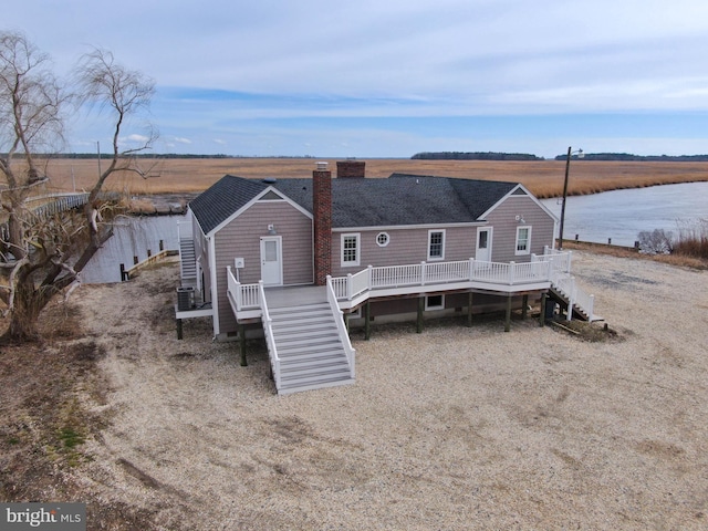 3706 Bestpitch Ferry Rd, Cambridge, MD 21613 - back of house with stairway, a deck with water view, and a chimney