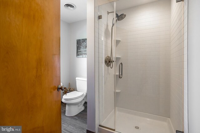 3706 Bestpitch Ferry Rd, Cambridge, MD 21613 - full bathroom featuring a stall shower, toilet, and wood finished floors