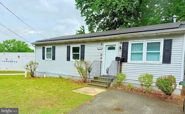 195 Mitscher Rd, Dover, DE 19901 - view of front of house with a front lawn and roof mounted solar panels