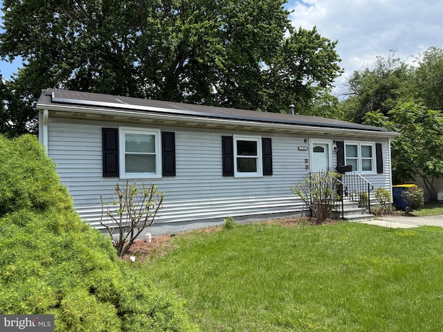195 Mitscher Rd, Dover, DE 19901 - view of front of property with a front lawn and roof mounted solar panels