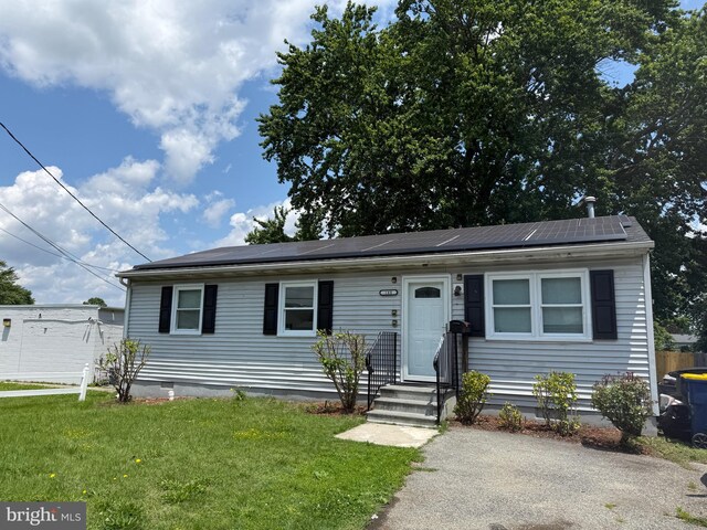 195 Mitscher Rd, Dover, DE 19901 - view of front of house featuring a front lawn, roof mounted solar panels, and entry steps