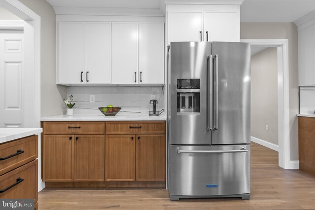 20 Hathaway Dr, Princeton Junction, NJ 08550 - kitchen featuring stainless steel fridge with ice dispenser, light countertops, light wood-style floors, tasteful backsplash, and white cabinetry