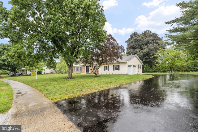 20 Hathaway Dr, Princeton Junction, NJ 08550 - view of front of home with a front yard, a water view, an attached garage, and driveway