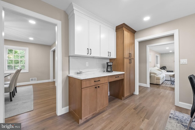 20 Hathaway Dr, Princeton Junction, NJ 08550 - kitchen featuring light wood finished floors, light countertops, baseboards, white cabinets, and decorative backsplash