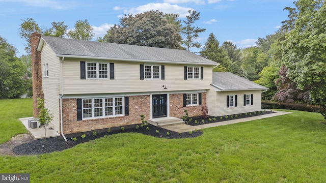 20 Hathaway Dr, Princeton Junction, NJ 08550 - colonial-style house with a front lawn, a chimney, brick siding, and central AC