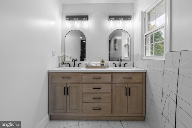 20 Hathaway Dr, Princeton Junction, NJ 08550 - bathroom featuring marble look tile flooring, double vanity, and tile walls