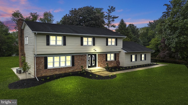 20 Hathaway Dr, Princeton Junction, NJ 08550 - colonial-style house with a yard, a chimney, brick siding, and central air condition unit