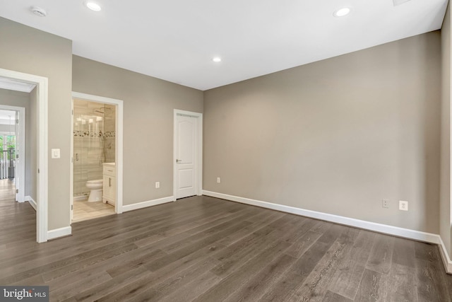 12723 Lady Somerset Ln, Fairfax, VA 22033 - unfurnished bedroom featuring dark wood-style floors, baseboards, recessed lighting, and connected bathroom