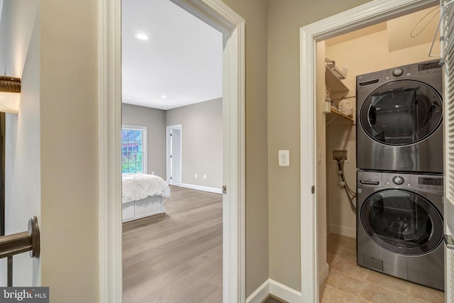 12723 Lady Somerset Ln, Fairfax, VA 22033 - laundry room featuring stacked washing machine and dryer, baseboards, and wood finished floors