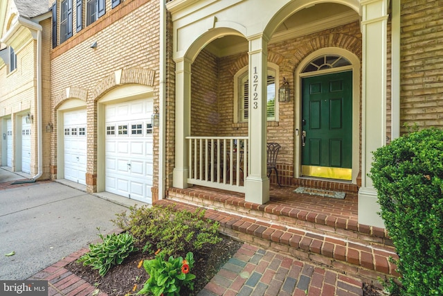 12723 Lady Somerset Ln, Fairfax, VA 22033 - doorway to property with driveway, a porch, brick siding, and an attached garage