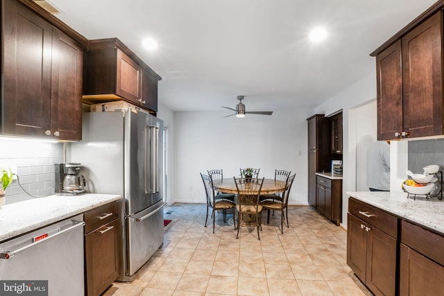 9213 Fairlane Pl, Laurel, MD 20708 - kitchen with stainless steel appliances, ceiling fan, backsplash, dark brown cabinetry, and light stone countertops