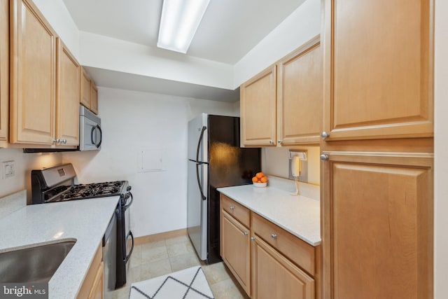 2510 Virginia Ave NW Unit 2Bn, Washington, DC 20037 - kitchen featuring stainless steel appliances, light brown cabinetry, light stone countertops, baseboards, and a sink