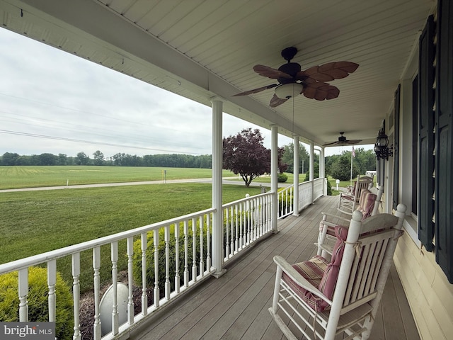 663 Tomlin Station Rd, Mullica Hill, NJ 08062 - wooden porch with ceiling fan, a yard, and a view of rural / pastoral area