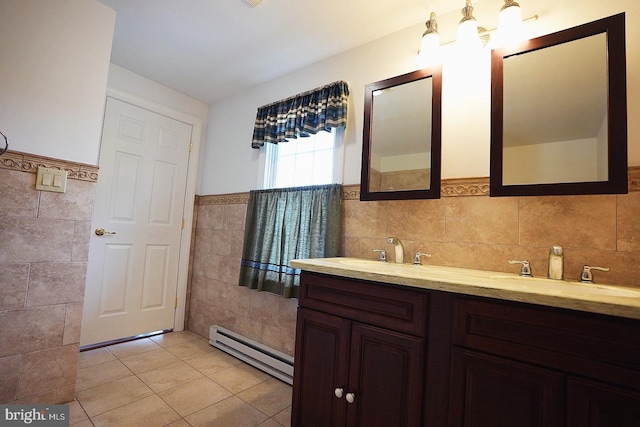 663 Tomlin Station Rd, Mullica Hill, NJ 08062 - bathroom featuring tile walls, a baseboard heating unit, a wainscoted wall, tile patterned floors, and double vanity