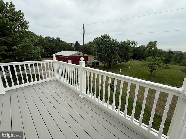 663 Tomlin Station Rd, Mullica Hill, NJ 08062 - deck featuring a lawn, a detached garage, and an outbuilding