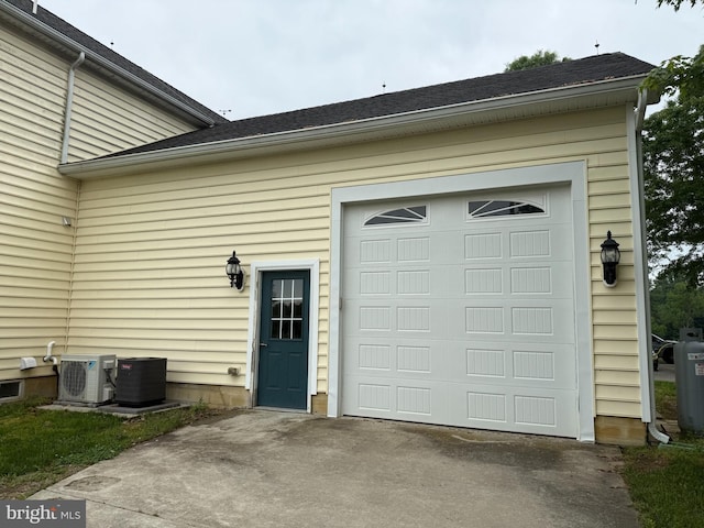 663 Tomlin Station Rd, Mullica Hill, NJ 08062 - garage featuring a cooling unit, concrete driveway, and central air condition unit