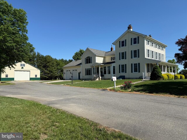 663 Tomlin Station Rd, Mullica Hill, NJ 08062 - view of front of home with a chimney, a detached garage, a front yard, and entry steps
