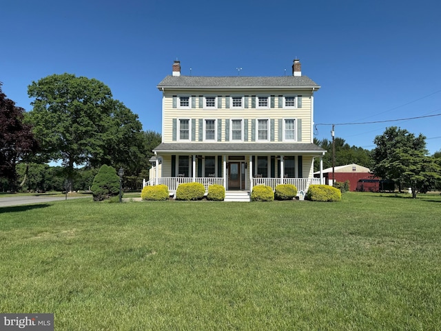 663 Tomlin Station Rd, Mullica Hill, NJ 08062 - colonial home with covered porch, a front yard, and a chimney