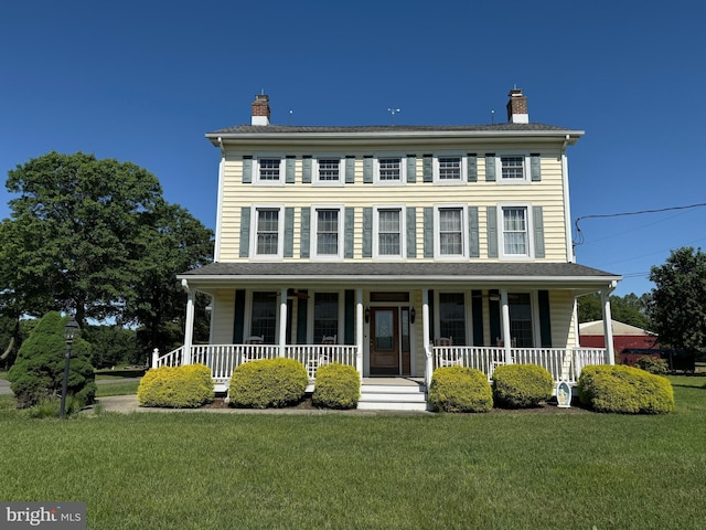 663 Tomlin Station Rd, Mullica Hill, NJ 08062 - colonial house featuring covered porch, a chimney, and a front yard