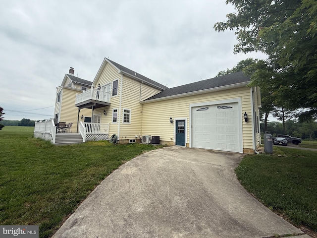 663 Tomlin Station Rd, Mullica Hill, NJ 08062 - view of side of property featuring a garage, a yard, concrete driveway, a chimney, and a balcony