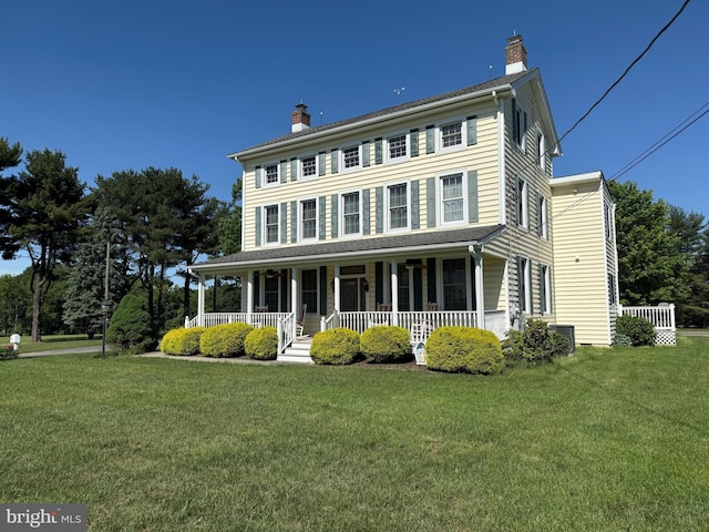 663 Tomlin Station Rd, Mullica Hill, NJ 08062 - colonial home with a porch, a chimney, and a front lawn