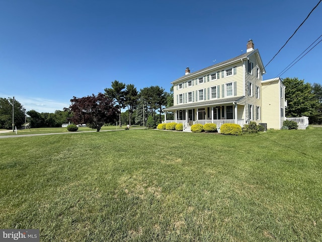 663 Tomlin Station Rd, Mullica Hill, NJ 08062 - rear view of house featuring a porch, a chimney, and a lawn