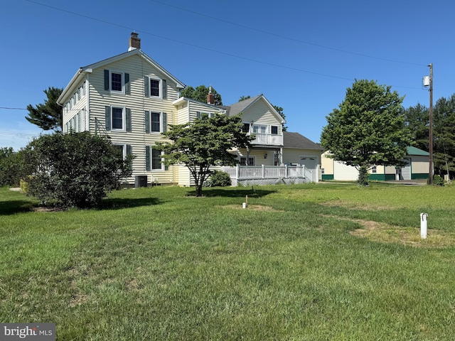 663 Tomlin Station Rd, Mullica Hill, NJ 08062 - rear view of house with a chimney, a yard, and central AC unit