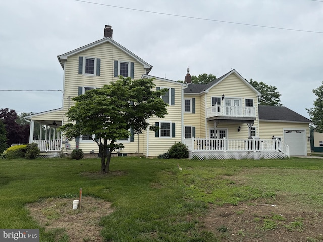663 Tomlin Station Rd, Mullica Hill, NJ 08062 - back of property featuring a balcony, a lawn, a chimney, and covered porch