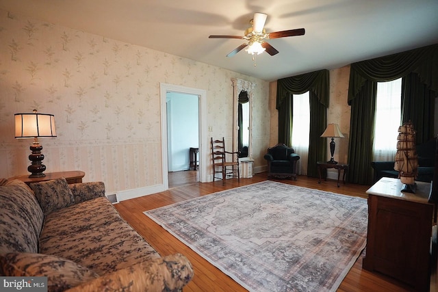 663 Tomlin Station Rd, Mullica Hill, NJ 08062 - living area with a ceiling fan, wood finished floors, wallpapered walls, and baseboards