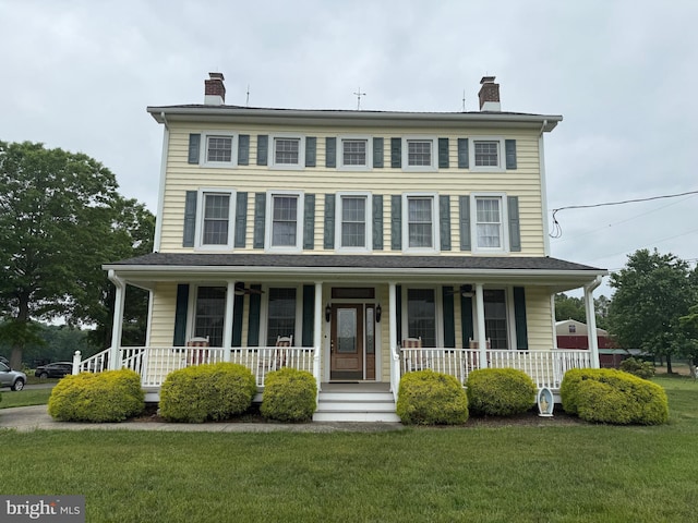 663 Tomlin Station Rd, Mullica Hill, NJ 08062 - view of front of property with a chimney, a porch, and a front lawn