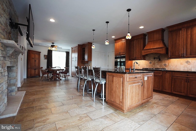 663 Tomlin Station Rd, Mullica Hill, NJ 08062 - kitchen featuring a ceiling fan, custom range hood, a breakfast bar area, a sink, and tasteful backsplash