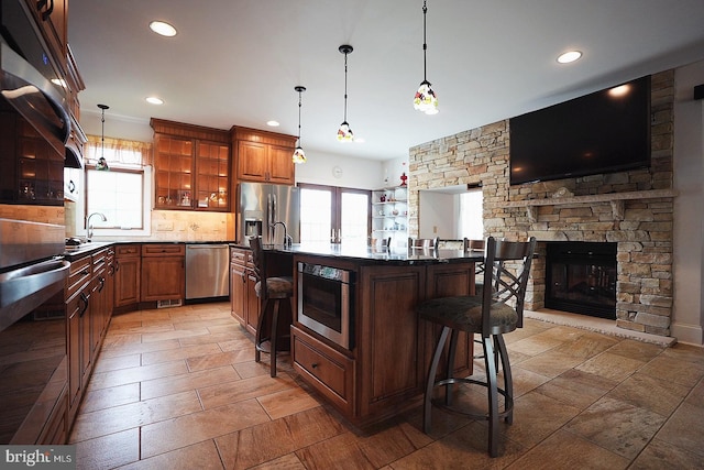 663 Tomlin Station Rd, Mullica Hill, NJ 08062 - kitchen with appliances with stainless steel finishes, a kitchen breakfast bar, open shelves, recessed lighting, and glass insert cabinets