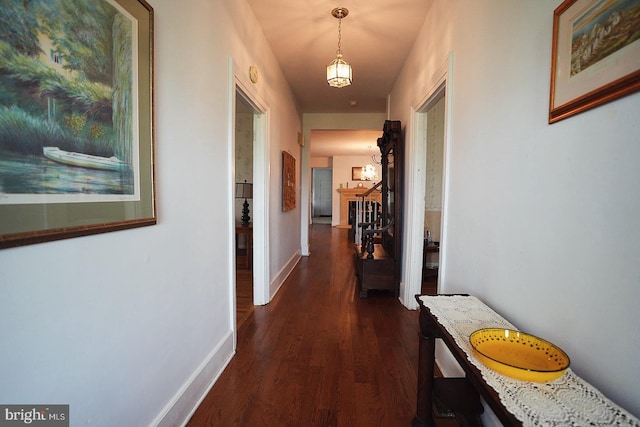 663 Tomlin Station Rd, Mullica Hill, NJ 08062 - corridor with dark wood-type flooring, stairway, baseboards, and a chandelier